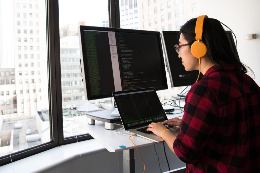 woman coding at computer at work, digital marketing, marketing agency