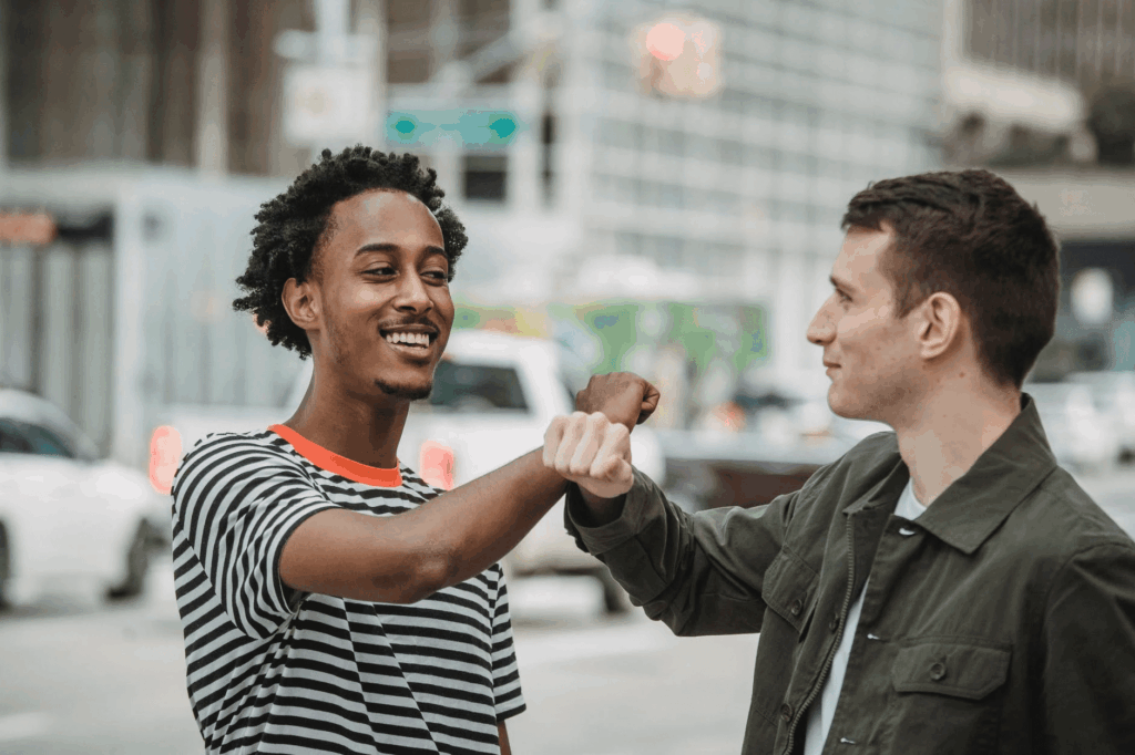friends fist bumping during covid pandemic