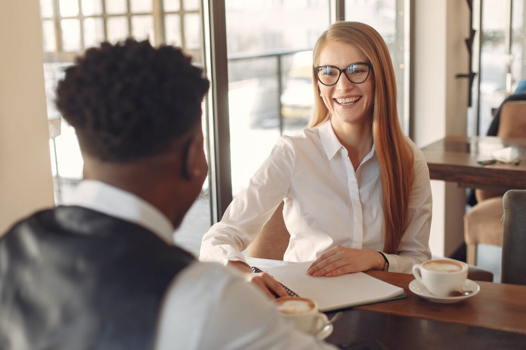 Coaching Improves Employee Well-Being, Forbes, boss and employee talking, pr agency