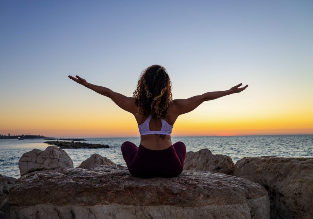 woman meditating at beach, mental health