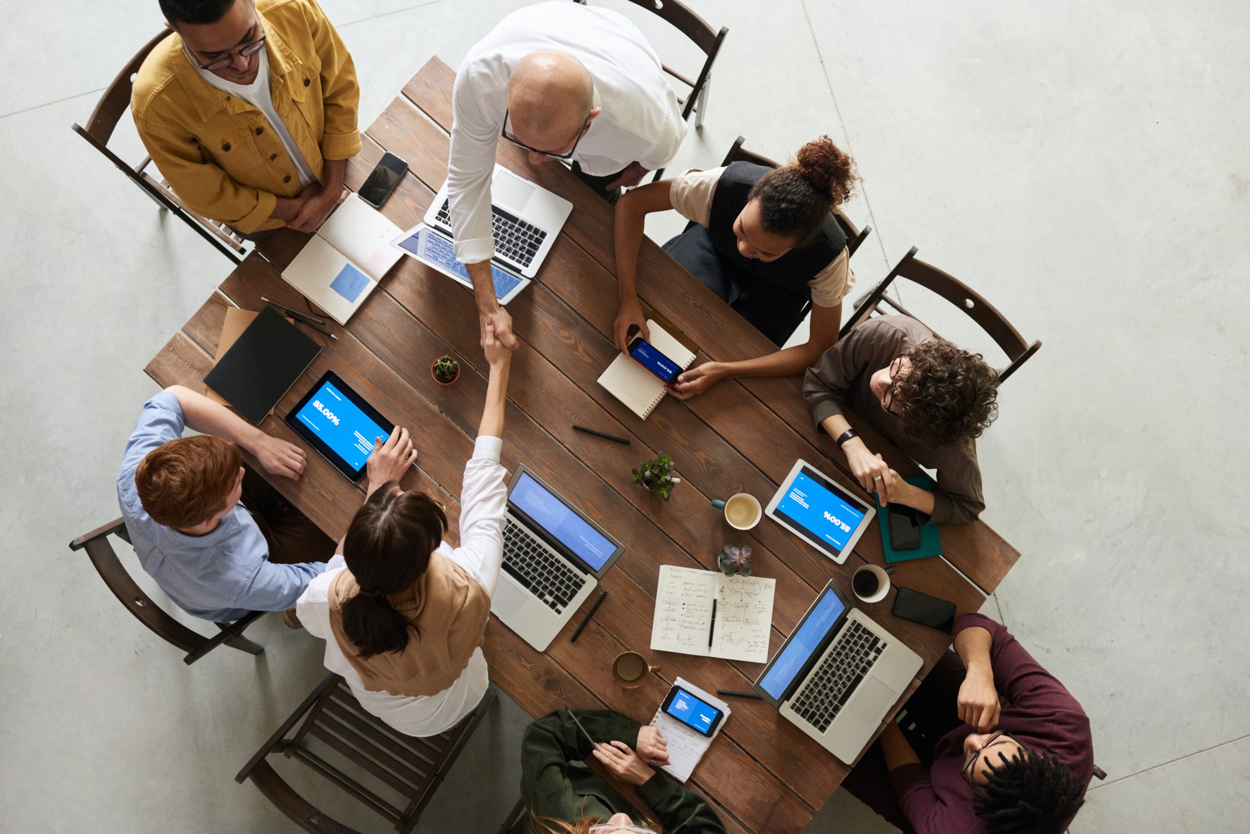 coworkers working together in office with laptops